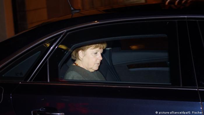 Angela Merkel departs the coalition talks in the darkness