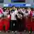 Female hockey players from North and South Korea pose together for the camera
