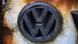 A rusty VW logo A rusty VW logo