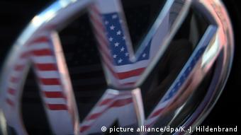 A US flag reflects on a VW grill logo
