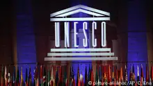 The logo of the United Nations Educational, Scientific and Cultural Organisation (UNESCO) is seen during the 39th session of the General Conference at the UNESCO headquarters in Paris, Saturday, Nov. 4, 2017. (AP Photo/Christophe Ena) |