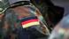 A German flag on the shoulder of a Bundeswehr soldier A German flag on the shoulder of a Bundeswehr soldier
