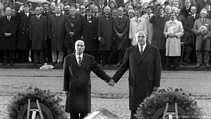 Helmut Kohl and Francois Mitterrand clasp hands at the Verdun memorial in 1984