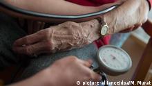 ARCHIV - Eine Bewohnerin der Seniorenwohnanlage Ludwigstift bekommt am 11.02.2015 in Stuttgart (Baden-Württemberg) den Blutdruck gemessen. Foto: Marijan Murat/dpa (zu lsw Zusammenfassung: «Flüchtlinge als Potential für Pflegekräfte» vom 05.07.2015) +++(c) dpa - Bildfunk+++ | Verwendung weltweit