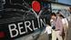 Visitors from China walk past murals on the former Berlin Wall at the East Side Gallery on August 5, 2014 in Berlin, Germany Visitors from China walk past murals on the former Berlin Wall at the East Side Gallery on August 5, 2014 in Berlin, Germany