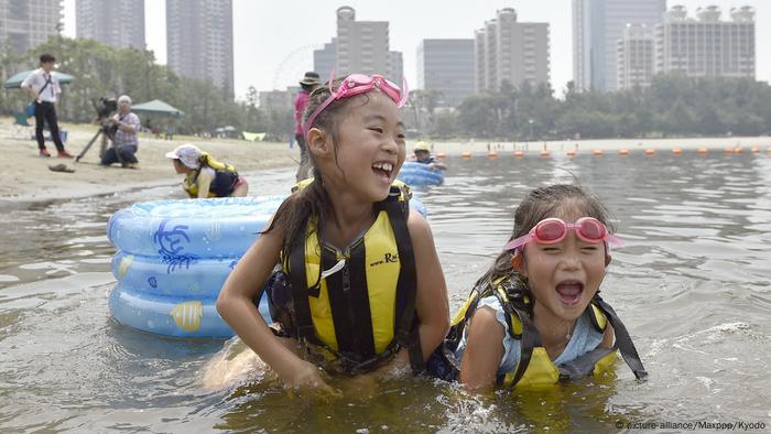 Children swim in Odaiba Bay in Japan