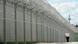 An officer walks along the wall of a high-security prison in Frankfurt An officer walks along the wall of a high-security prison in Frankfurt