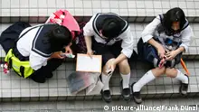 12.05.2009 +++ Schulmädchen sitzen auf einer Treppe in Shibuya neben einem Kaufhaus. | Verwendung weltweit