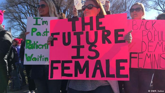 A demonstrater holds up a sign that reads 'The future is female'