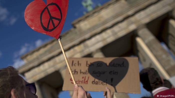 A peace sign held up during a demonstration for peace in Berlin in 2014