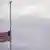 The American flag flies at half staff over the White House