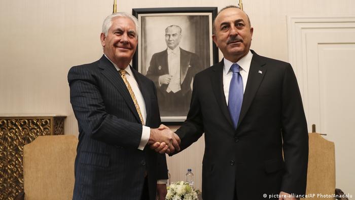 US Secretary of State Rex Tillerson shakes the hand of Turkish Foreign Minister Mevlut Cavusoglu