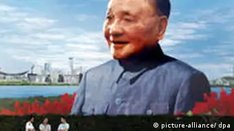 Touristen vor einem Porträt von Deng Xiaoping