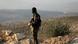 A Free Syrian Army soldier looking out from a ridgetop A Free Syrian Army soldier looking out from a ridgetop