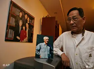 Bao Tong, right, poses for photo near a picture of Zhao Ziyang, the Chinese leader ousted for opposing the crackdown on the 1989 Tiananmen square democracy movement, at his home in Beijing, China, Friday, May 15, 2009. Bao who was then a top aide to Zhao, hopes Zhao's posthumous memoirs which are to be published just weeks before the 20th anniversary of the crackdown will provide lessons to China's future generation and top leaders. (AP Photo/Ng Han Guan)