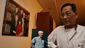 Bao Tong, right, poses for photo near a picture of Zhao Ziyang, the Chinese leader ousted for opposing the crackdown on the 1989 Tiananmen square democracy movement, at his home in Beijing, China, Friday, May 15, 2009. Bao who was then a top aide to Zhao, hopes Zhao's posthumous memoirs which are to be published just weeks before the 20th anniversary of the crackdown will provide lessons to China's future generation and top leaders. (AP Photo/Ng Han Guan)