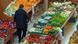 A man in the fruit and vegetable section of a grocery store A man in the fruit and vegetable section of a grocery store