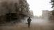 Man running through the dust in Eastern Ghouta Man running through the dust in Eastern Ghouta