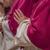 A priest holds his hands together in prayer