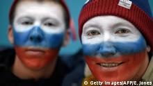 This photo taken on February 17, 2018 shows Russia fans posing for a photo before the men's preliminary round ice hockey match between the US and Olympic Athletes from Russia during the Pyeongchang 2018 Winter Olympic Games at the Gangneung Hockey Centre in Gangneung. / AFP PHOTO / Ed JONES (Photo credit should read ED JONES/AFP/Getty Images)