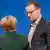 Jens Spahn (L) standing in conversation with Merkel whose back is towards the photographer at last year's CDU party conference in Essen, Germany.