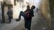 Man carrying wounded man in eastern Ghouta Man carrying wounded man in eastern Ghouta