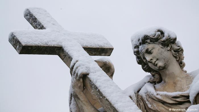 A statue is seen covered in snow during a heavy snowfall in Rome.