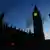 Silhouette of the Houses of Parliament with a red stoplight