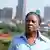South Africa: climate activist and artist Ndivile Mokoena in front of Johannesburg skyline