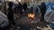 Migrants warm themselves around a bonfire in Paris, February 2018 Migrants warm themselves around a bonfire in Paris, February 2018