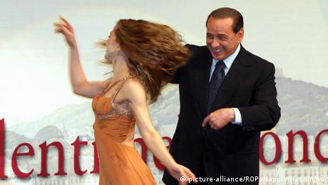 Silvio Berlusconi dances with a woman