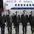 South Korean officials stand in front of a plane before flying to North Korea