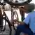 Žena u Namibiji popravlja bicikl