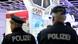 Police officers seen from behind at the ITB trade fair Police officers seen from behind at the ITB trade fair