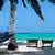 tropischer Strand mit Palmen, Liegestühlen und Hängematte, tropical beach with palm trees, hammock and canvas chairs