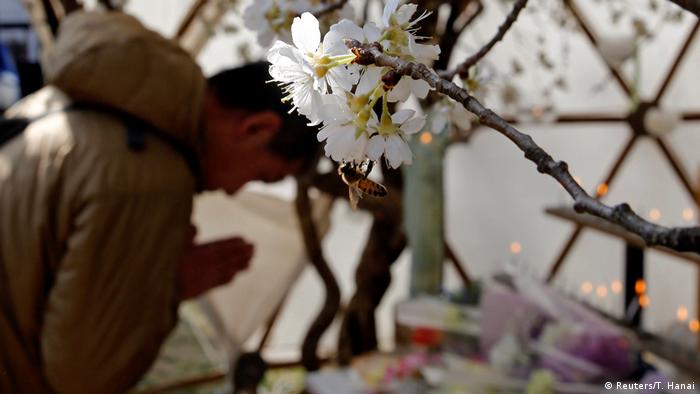 Participants attend a moment of silence at 2:46 p.m. (0546 GMT), the time when the magnitude 9.0 earthquake struck off Japan's coast in 2011