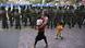 A Chinese Uighur woman walk past a line of soldiers in Urumqi, Xinjiang province A Chinese Uighur woman walk past a line of soldiers in Urumqi, Xinjiang province