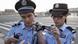 Zwei chinesische Polizisten fotografieren Ausweise von Journalisten (Foto: dpa) Zwei chinesische Polizisten fotografieren Ausweise von Journalisten (Foto: dpa)