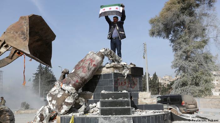 Syria - FSA forces tear down Kurdish statue in Afrin