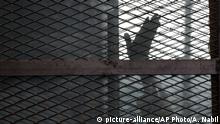 FILE - In this Aug. 22, 2015 file photo, a Muslim Brotherhood member gestures from a defendants cage in a courtroom in Torah prison, southern Cairo, Egypt. Human Rights Watch, an international rights group, is alleging systematic torture inside Egyptian police stations and Interior Ministry headquarters where officers act in ?almost total impunity.? In a 63-page study released Wednesday, Aug. 6, 2017, HRW said President Abdel-Fattah el-Sissi's pursuit of stability comes ?at any cost.? (AP Photo/Amr Nabil, File) |