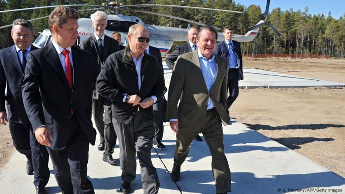 Gazprom Chief Executive Officer Alexei Miller (l), Vladimir Putin, and former German chancellor Gerhard Schröder and others arriving by helicopter