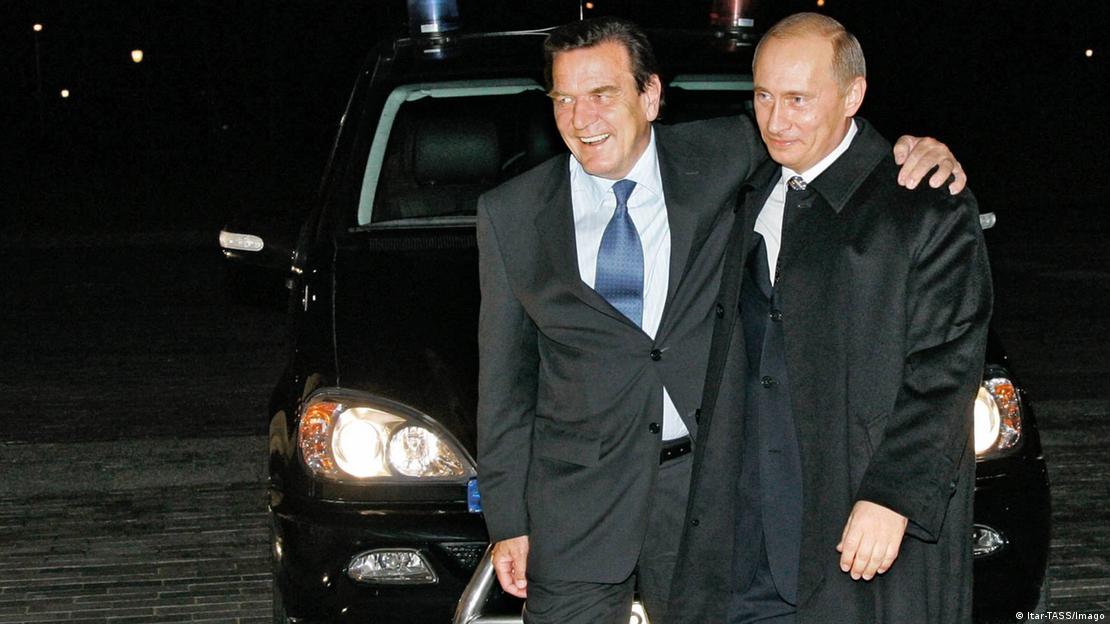 Gerhard Schröder and Vladimir Putin walking together