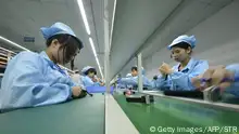 TO GO WITH China-US-IT-Internet-lifestyle-Apple,FOCUS by Tom Hancock
This picture taken on April 22, 2015 shows Chinese workers assembling a cheaper local alternative to the Apple Watch in a factory producing thousands every day in Shenzhen, in southern China's Guangdong province. The much-hyped Apple Watch goes on sale on April 24, but Chinese factories are already churning out cheaper alternatives to the apparent delight of local consumers. CHINA OUT AFP PHOTO (Photo credit should read STR/AFP/Getty Images)