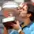 French Open tennis champion Roger Federer kisses trophy