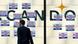 A man with a case walks past the Arcandor logo A man with a case walks past the Arcandor logo