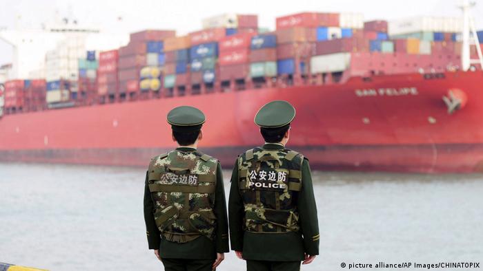 Chinese police watch over a shipping containe