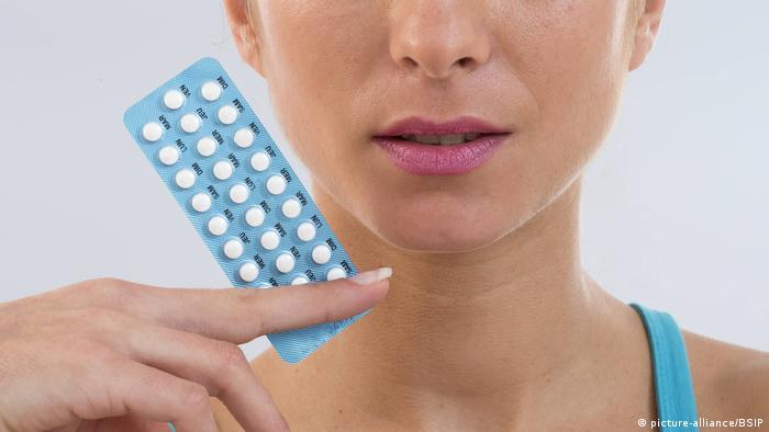 Woman holding blister of birth control pill