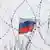 Российский флаг за колючей проволокой