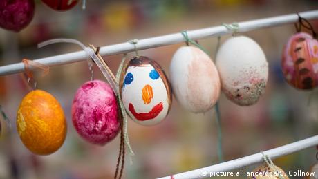 Decorated eggs hanging on a fence