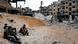 Three Syrian soldiers sitting on an embankment Three Syrian soldiers sitting on an embankment